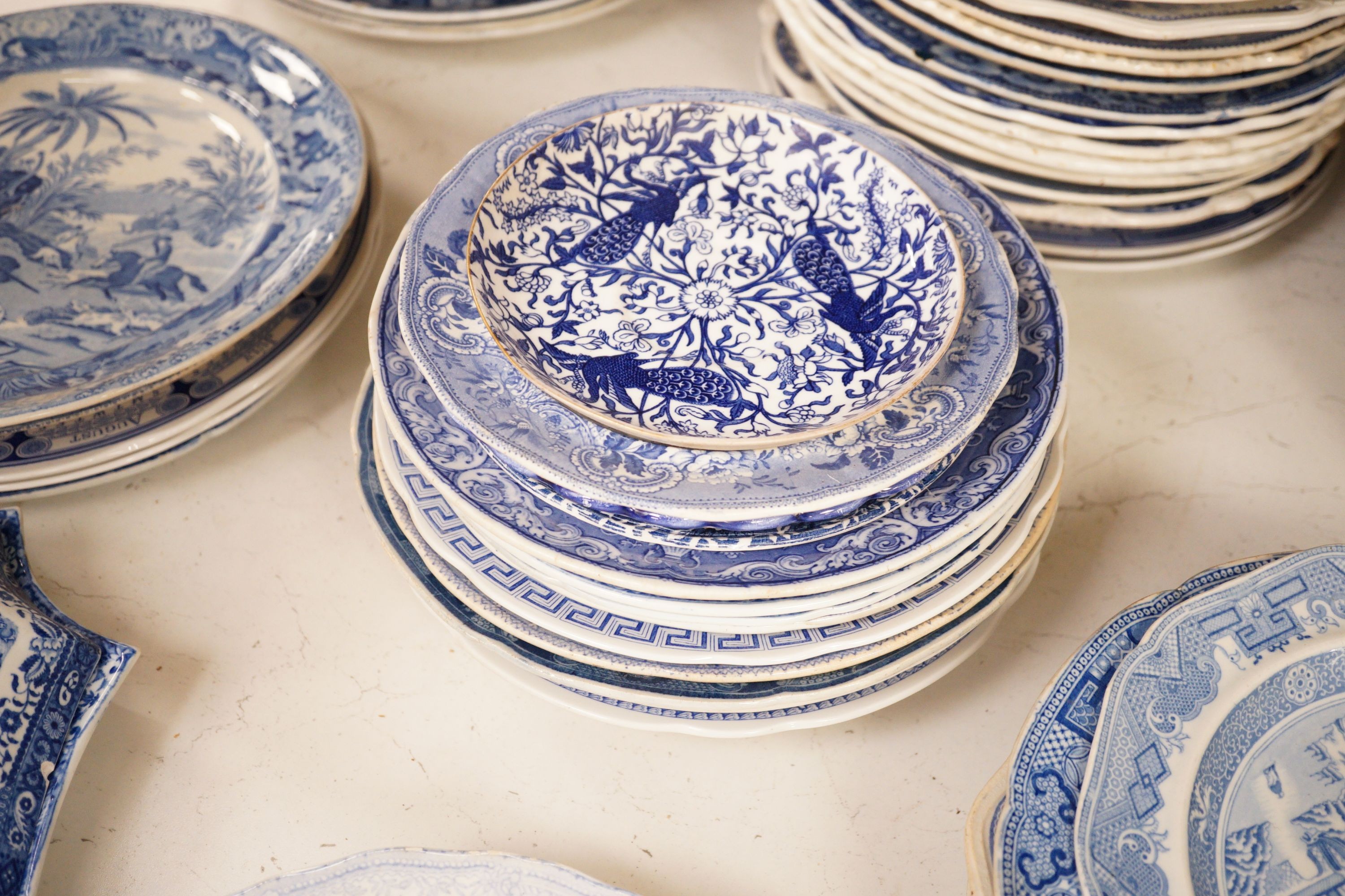 A collection of mostly 19th century blue and white transfer printed pottery tablewares